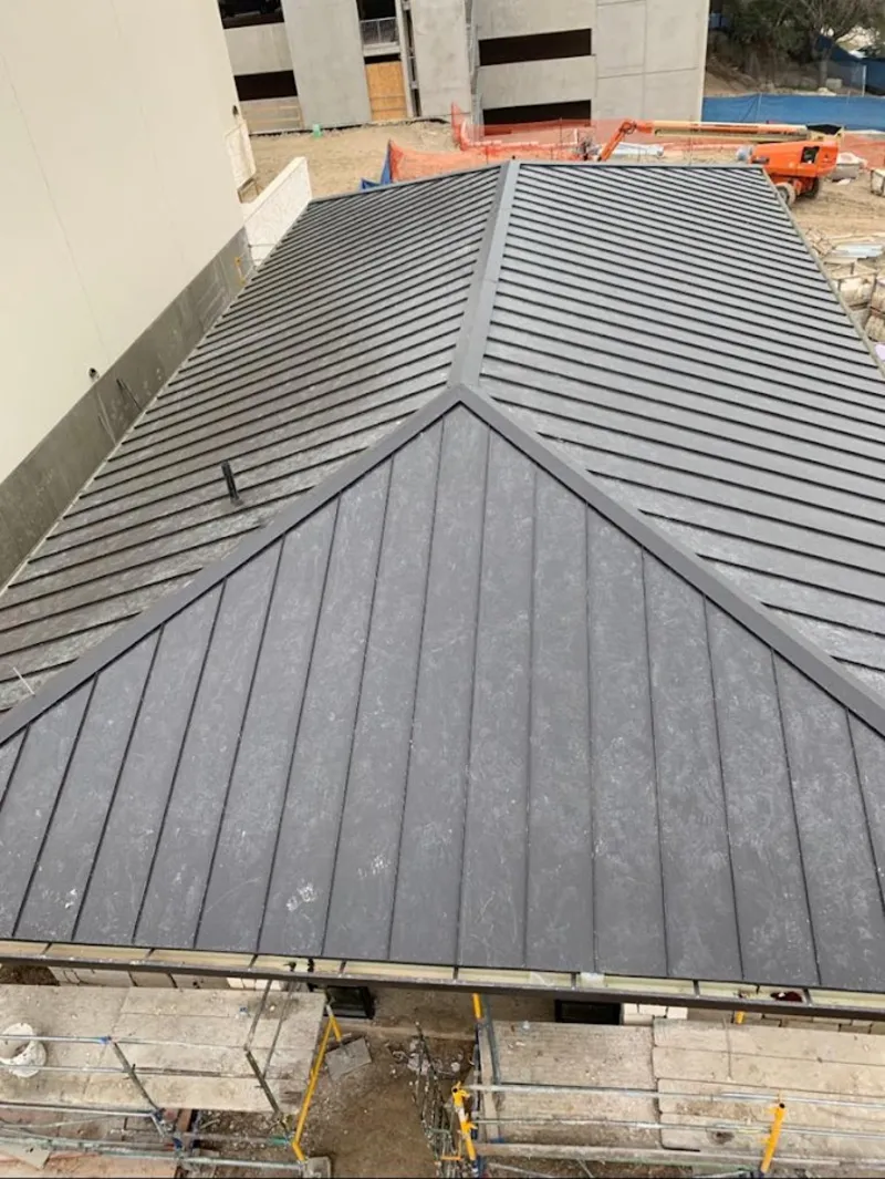 Commercial metal roof construction with crane equipment in New Franklin