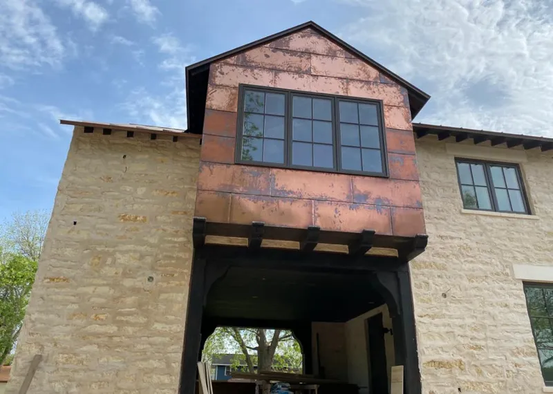 Copper metal panel facade on a stone building for Metal Roof Coating in New Franklin